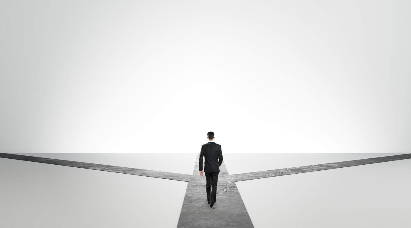 Photo illustration of man at career crossroads