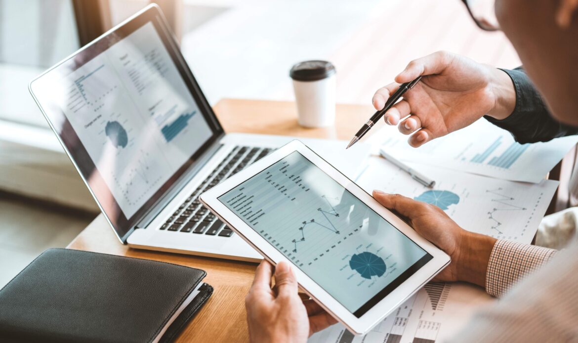 Two people look at iPad